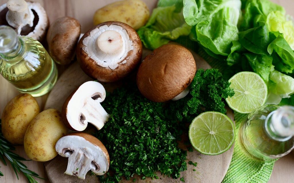 mushrooms, cilantro, potatoes, and lime on a table
